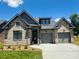Beautiful brick home featuring a two-car garage and well-manicured lawn on a sunny day at 32 Shanklin S Ln # 32, Denver, NC 28037