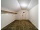 Attic with low ceilings, neutral carpet, a light fixture and a door at 4210 Wrangler Sw Dr, Concord, NC 28027