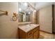 Bathroom featuring a single sink vanity with a mirror and shower reflected in the mirror at 4210 Wrangler Sw Dr, Concord, NC 28027