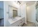 Bright bathroom featuring double sink vanity and a shower with glass doors at 4210 Wrangler Sw Dr, Concord, NC 28027