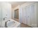 Bright bathroom featuring double sinks, a shower, and plenty of storage with closet at 4210 Wrangler Sw Dr, Concord, NC 28027
