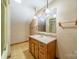 Bathroom featuring a single sink vanity with a mirror and shower reflected in the mirror at 4210 Wrangler Sw Dr, Concord, NC 28027