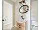 Modern bathroom featuring a wood vanity, dark fixtures and a large oval mirror at 4210 Wrangler Sw Dr, Concord, NC 28027