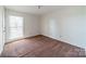A sunlit bedroom featuring a large window and carpeted floors at 4210 Wrangler Sw Dr, Concord, NC 28027