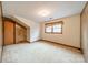 Bedroom features neutral carpet, natural light from the window, and a door in the paneled wall at 4210 Wrangler Sw Dr, Concord, NC 28027