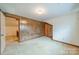 Bedroom features neutral carpet and paneled walls, with an open doorway to another bedroom at 4210 Wrangler Sw Dr, Concord, NC 28027
