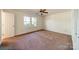 Bedroom featuring a large window, neutral paint and carpet, and a closet at 4210 Wrangler Sw Dr, Concord, NC 28027