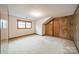 Bedroom features neutral carpet, natural light from the window, and a door in the paneled wall at 4210 Wrangler Sw Dr, Concord, NC 28027