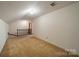 A carpeted bonus room with staircase, ideal for flexible living at 4210 Wrangler Sw Dr, Concord, NC 28027