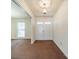 Cozy entryway with neutral carpet, white trim, and natural light at 4210 Wrangler Sw Dr, Concord, NC 28027