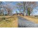 View of a ranch-style home with a long driveway leading to the front entrance at 4210 Wrangler Sw Dr, Concord, NC 28027