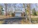 A detached garage with brick siding and a white garage door at 4210 Wrangler Sw Dr, Concord, NC 28027