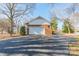 Spacious detached garage with brick facade and ample driveway parking at 4210 Wrangler Sw Dr, Concord, NC 28027