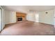 Open living room with brick fireplace, large window and ceiling fan at 4210 Wrangler Sw Dr, Concord, NC 28027