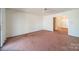 Spacious living room featuring neutral walls and carpet, leading to a bright foyer area at 4210 Wrangler Sw Dr, Concord, NC 28027