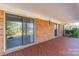 Covered back patio with brick flooring, offering a cozy outdoor space at 4210 Wrangler Sw Dr, Concord, NC 28027
