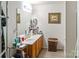 Bathroom featuring a double sink vanity, large mirror, wood accents, and neutral colors at 4716 Meadowfield Rd, Charlotte, NC 28215