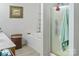 Well-lit bathroom showcasing a bathtub, glass-enclosed shower, vanity, and neutral tones at 4716 Meadowfield Rd, Charlotte, NC 28215