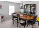 Dining room featuring a large table, chairs, and a decorative display cabinet next to the window at 4716 Meadowfield Rd, Charlotte, NC 28215