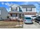 Charming two-story home with brick and siding, a welcoming front porch, and a well-maintained yard and driveway at 4716 Meadowfield Rd, Charlotte, NC 28215