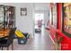 Hallway with hardwood floors transitioning into carpet and bright red accent wall, leading to various rooms at 4716 Meadowfield Rd, Charlotte, NC 28215