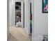 Hallway with a closet with shelving, and a painting on the wall at 4716 Meadowfield Rd, Charlotte, NC 28215