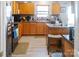 Comfortable kitchen featuring wooden cabinets, granite countertops, tile backsplash, and an island with seating at 4716 Meadowfield Rd, Charlotte, NC 28215