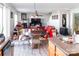 Open-concept living room with fireplace, red sofa, a glass table, and hardwood floors; bright and inviting at 4716 Meadowfield Rd, Charlotte, NC 28215
