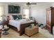 Bright bedroom with white walls, a ceiling fan, and a wooden bed frame; tranquil retreat at 4716 Meadowfield Rd, Charlotte, NC 28215