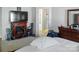 A main bedroom featuring a fireplace, TV, dresser, and an en-suite bathroom at 4716 Meadowfield Rd, Charlotte, NC 28215