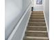 Carpeted stairway with painted banisters at 4716 Meadowfield Rd, Charlotte, NC 28215