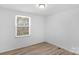 Bedroom featuring a window with wooded views, neutral walls and floors at 5226 Fair Wind Ln, Charlotte, NC 28212