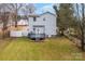 Backyard view of a two-story home with a deck and fenced yard at 590 Main Sw St, Concord, NC 28027