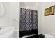 Cozy bathroom features a vanity sink with a shower and patterned curtain at 590 Main Sw St, Concord, NC 28027