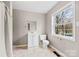 Neutral bathroom featuring a white vanity, toilet, and window at 590 Main Sw St, Concord, NC 28027