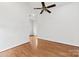 Clean bedroom featuring hardwood floors and a ceiling fan at 590 Main Sw St, Concord, NC 28027