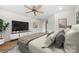 Comfortable bedroom features a ceiling fan, a large TV, and neutral colors at 590 Main Sw St, Concord, NC 28027