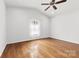 Bright bedroom featuring hardwood floors, a ceiling fan, and neutral décor at 590 Main Sw St, Concord, NC 28027