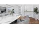 Another view of the open dining room with a modern marble table set at 590 Main Sw St, Concord, NC 28027