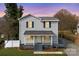 Charming two-story home with gray siding, black shutters, and a welcoming front porch at 590 Main Sw St, Concord, NC 28027
