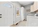 Functional laundry room with a washer, dryer, and storage cabinets at 590 Main Sw St, Concord, NC 28027