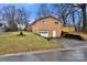 Rear view of brick home with garage and a drive way at 7047 Cheyenne Dr, Charlotte, NC 28262