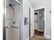 Bright bathroom features a shower with grab bar and a conveniently located laundry area at 7047 Cheyenne Dr, Charlotte, NC 28262