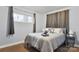 Comfortable bedroom with a large window, curtains, and bedside tables at 7047 Cheyenne Dr, Charlotte, NC 28262