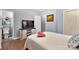 Cozy bedroom featuring a TV, storage cabinet, and a view into the en-suite bathroom at 7047 Cheyenne Dr, Charlotte, NC 28262