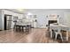 Open kitchen with island, fireplace and adjacent dinning area at 7047 Cheyenne Dr, Charlotte, NC 28262