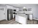 Modern kitchen with stainless steel appliances, granite countertops, and an island at 7047 Cheyenne Dr, Charlotte, NC 28262