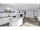 Open-concept kitchen with granite countertops, island, and view into the living room at 7047 Cheyenne Dr, Charlotte, NC 28262