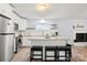 Bright kitchen features an island with seating, white cabinets, and stainless steel appliances at 7047 Cheyenne Dr, Charlotte, NC 28262