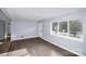 Bright living room featuring hardwood floors, a large window, and ample natural light at 7047 Cheyenne Dr, Charlotte, NC 28262